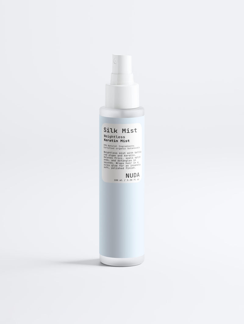 NUDA Silk Mist weightless keratin mist in a pale blue spray bottle