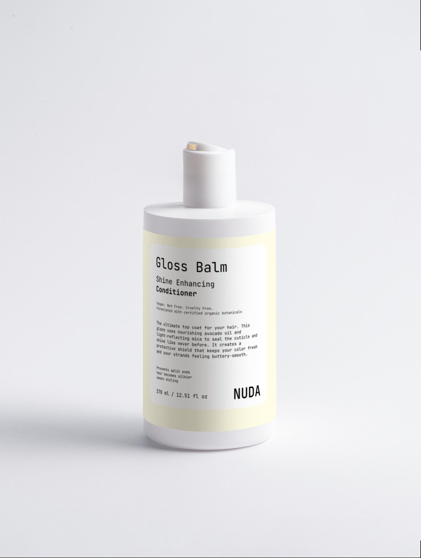 NUDA Gloss Balm shine enhancing conditioner bottle on a white background