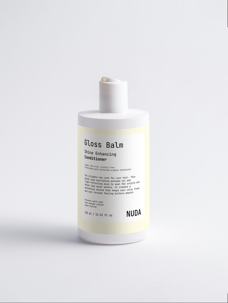 NUDA Gloss Balm shine enhancing conditioner bottle on a white background